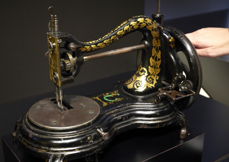 Experience an early hand crank sewing machine
